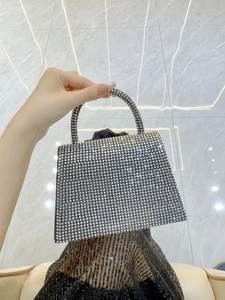 Close-up of sparkling silver rhinestones on a square evening clutch bag with top handle