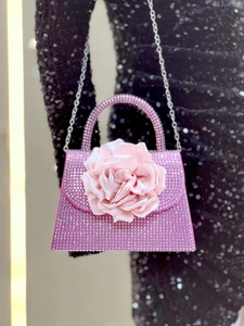Detail of pink crystal evening bag with large satin rose and beaded handle for parties