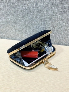 Interior view of black velvet evening clutch showing space for phone and lipstick