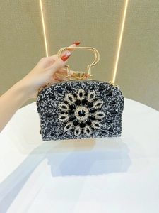 Detalle de bolso de noche con radiante diseño floral de diamantes de imitación en blanco y negro