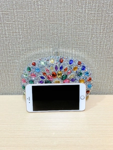 Detailed front view of a multi-color rhinestone evening clutch with gemstone embellishments