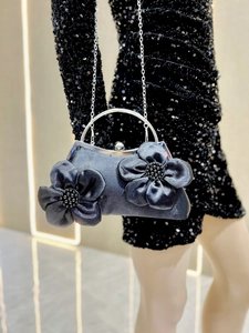 Detail of grey satin evening bag with handcrafted flowers and silver metal handle