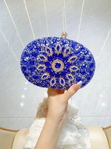 Macro view of sapphire blue floral rhinestones on luxury oval evening clutch bag