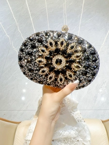 Close-up of a luxury oval evening clutch featuring radiant floral crystal rhinestones