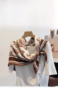 Detail of Toile de Jouy print scarf draped elegantly on a white mannequin neck