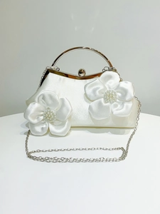 White satin evening clutch with 3D floral petals, silver ring handle and pearl details