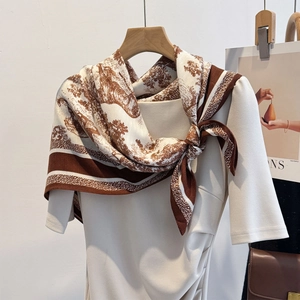 Elegant brown and beige silk scarf with Toile de Jouy pattern on a beige dress