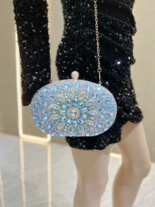 Detail of luxury oval evening clutch bag with light blue crystals and floral pattern