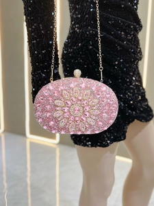 Detailed view of luxury pink crystal evening clutch with floral pattern and gold chain