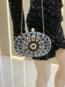Detailed view of luxury rhinestone evening bag with floral pattern and gold chain strap