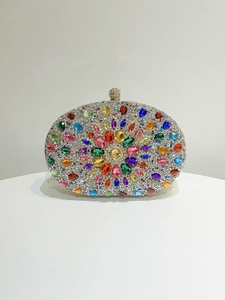 Macro detail of colorful oval gemstones and silver crystals on the luxury evening clutch