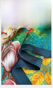 Detail of premium floral silk scarf showing precise hemmed edges and soft fabric texture