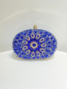 Detailed view of oval evening clutch with sapphire blue rhinestones and sunburst pattern