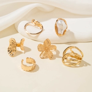 Detail view of 6pcs gold-tone ring set featuring imitation pearls and floral textures