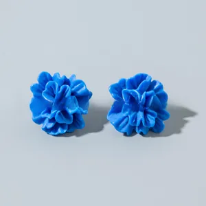 Detailed view of matte royal blue floral earrings with multi-layered 3D flower petals