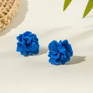 Close-up of elegant 3D blue floral stud earrings with matte finish and petal detail