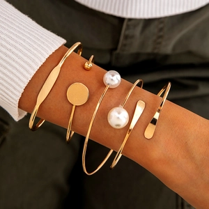 Five-piece gold minimalist cuff bracelet set with white faux pearls and metal discs