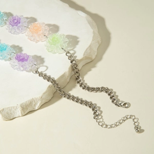 Macro shot of colorful translucent floral pendants on a silver metal chain accessory