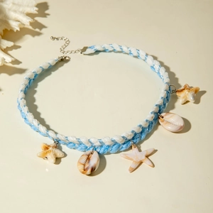 Detail of bohemian ocean necklace with starfish charms and shell pendants on woven cord