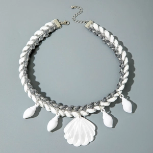 Detailed close-up of bohemian woven cord necklace with white seashells and starfish charms