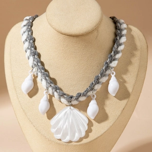 Detail of bohemian woven rope necklace with shell pendants and starfish charms