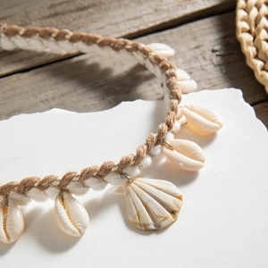 Detail view of Bohemian shell necklace with handwoven brown cord and natural seashells