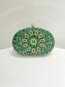 Detail of emerald green crystal evening bag with floral diamond patterns and gold clasp