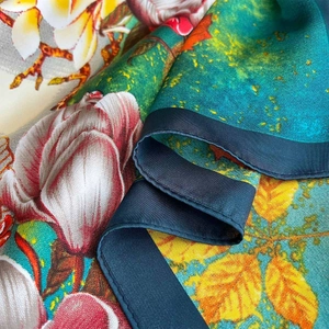 Floral satin silk square scarf with magnolia prints and navy blue hemmed edges