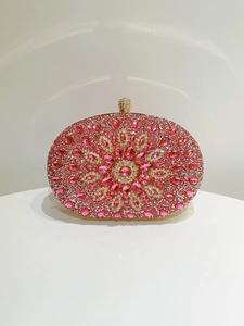 Detail of pink crystal encrusted evening clutch with gold spherical clasp and floral pattern