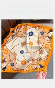 Close-up of floral square scarf featuring orange rose patterns and rope textures