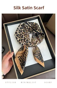 Close-up of leopard print square scarf made of smooth faux silk satin fabric texture