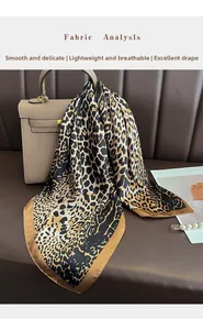 Close-up of leopard print silk scarf tied on handbag showing smooth texture and drape