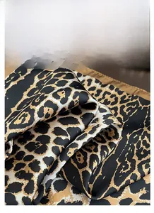 Detailed view of the smooth leopard print satin fabric with soft silky texture