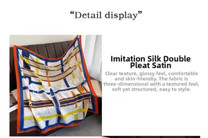 Detail of square silk-like scarf featuring belt and chain print in vibrant blue and orange