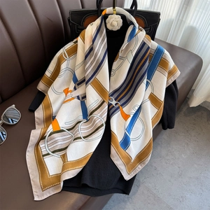 Luxurious equestrian print silk scarf with bridle motifs on a black knit background