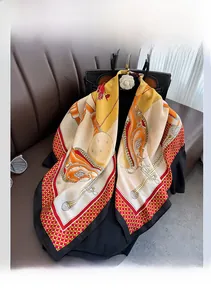 Close-up of lightweight silk scarf with red and gold equestrian patterns on leather