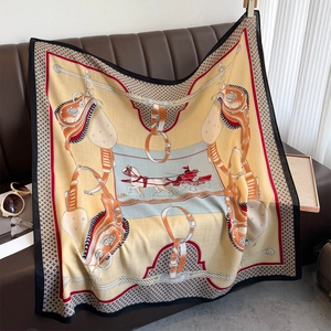 Detail of a large silk shawl with equestrian horse carriage print and orange borders