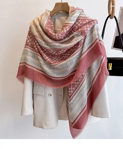 Close-up of ethnic geometric pattern shawl with delicate fringed edges on a suit