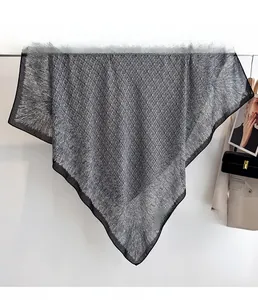 Detail showing the silver-grey fabric with metallic luster and fine geometric texture