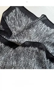 Detailed macro view of black and white coral pattern on lightweight summer silk scarf