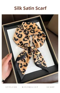 Macro detail of silk-like leopard print square scarf with smooth satin texture finish