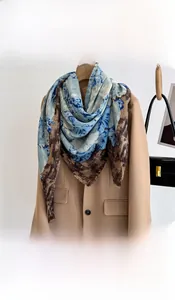 Detail of floral and leopard print scarf with soft frayed edges on a beige blazer
