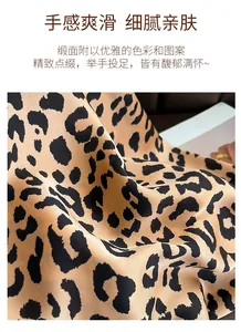 Close-up of leopard print satin scarf showing smooth silky texture and black border detail