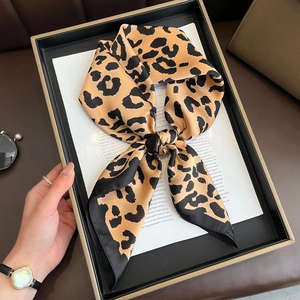 Elegant leopard print silk scarf with black borders, presented in a luxury gift box