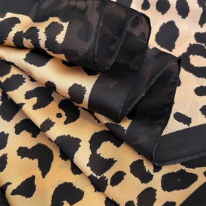 Leopard print faux silk scarf with black borders, lightweight chiffon texture for women