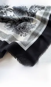 Detailed close-up of retro tropical print on lightweight fabric scarf with fringed edges