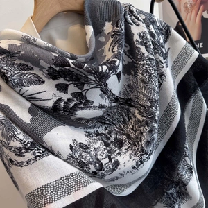 Detail of high-quality large scarf featuring tropical garden print and black borders