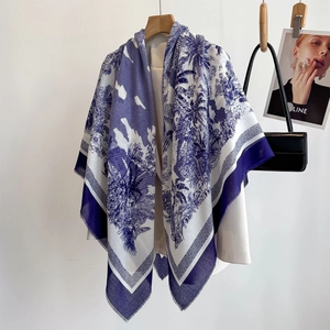 Blue and white tropical jungle print large shawl with fringe edges on white clothing
