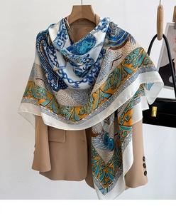 Detail of elegant large silk scarf with retro chain patterns on a beige blazer