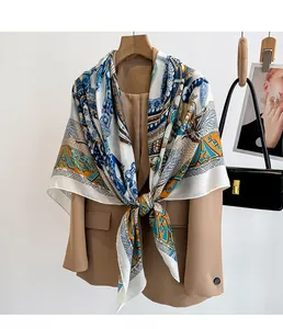 Detail of vintage geometric silk scarf draped over a blazer for office styling